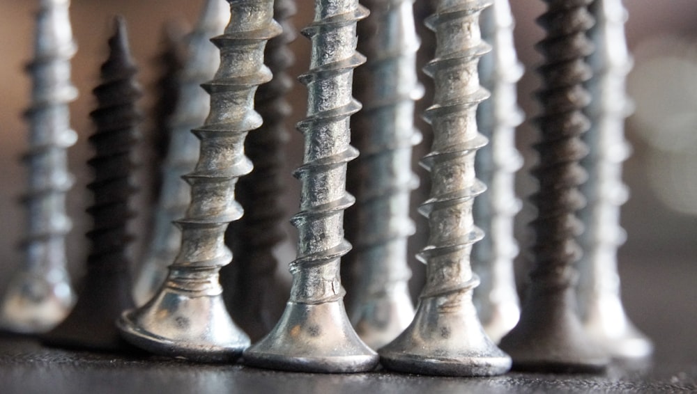 a row of screws sitting on top of a table