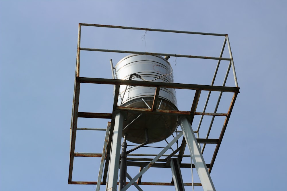 a tall metal tower with a sky background