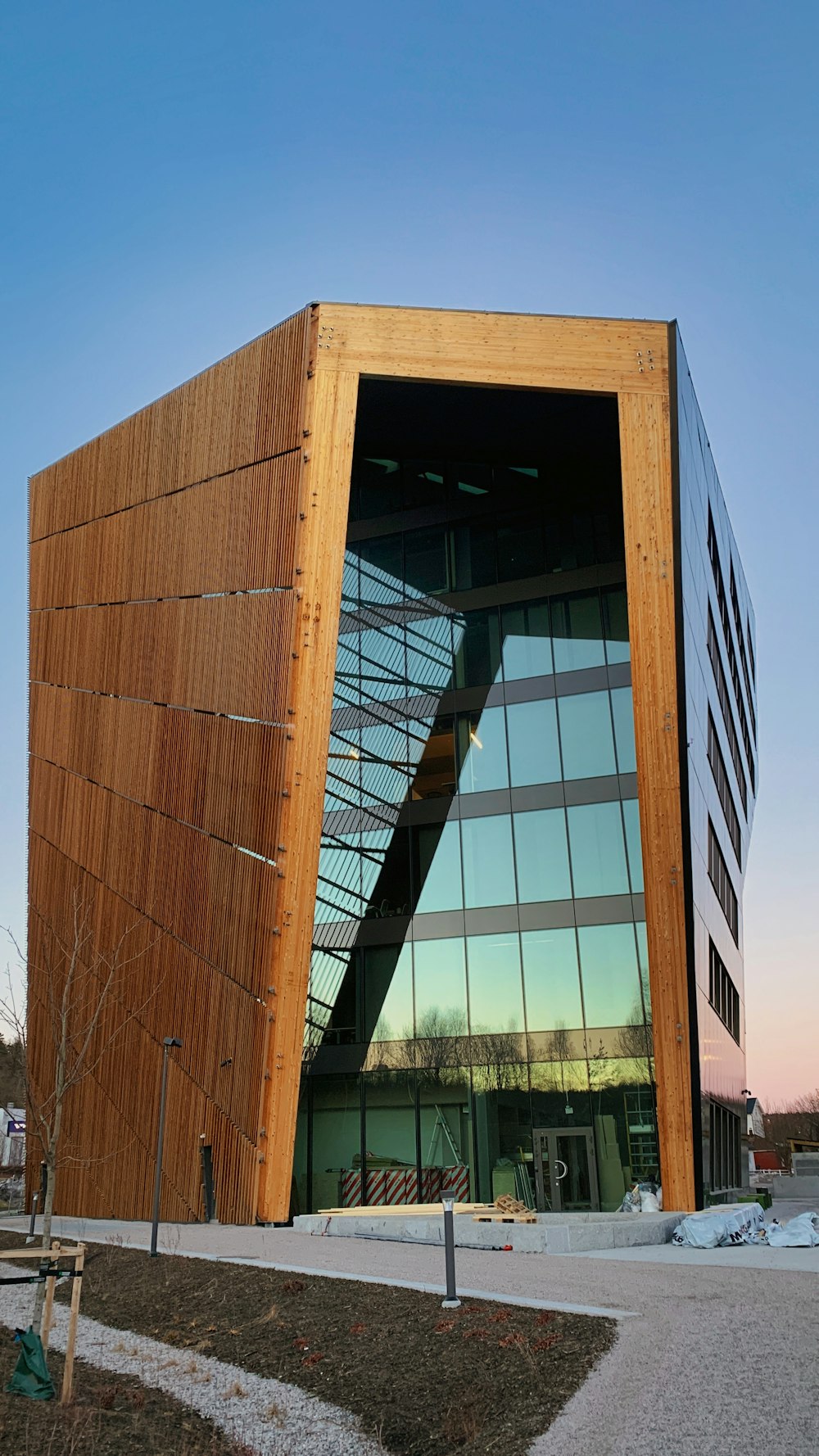 a large wooden building with a glass front