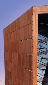 a large wooden building with a clock on it's side
