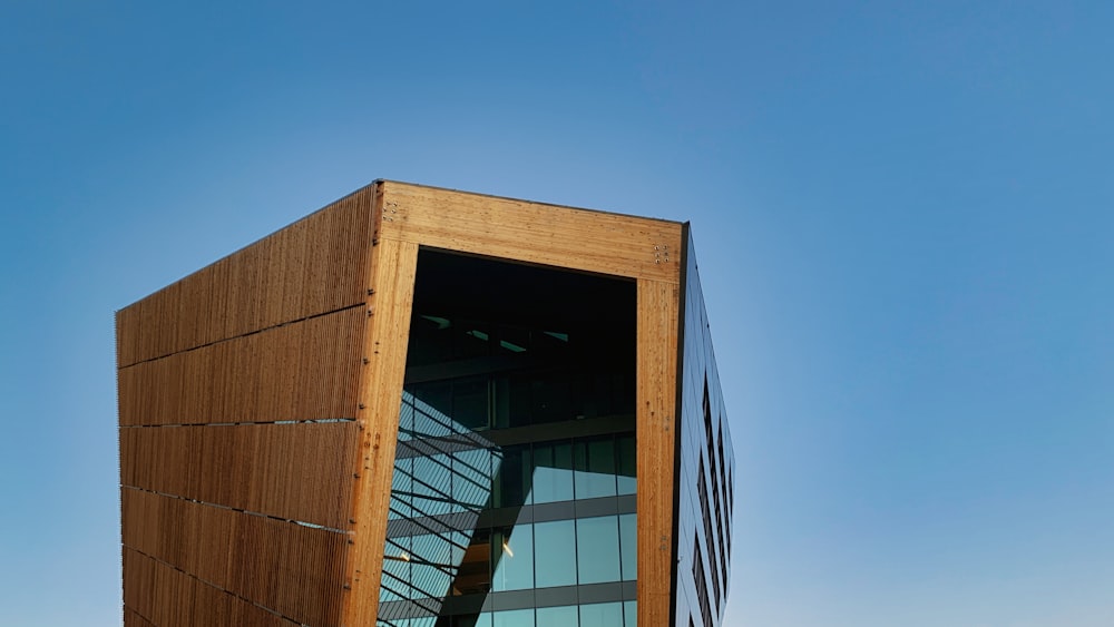 a tall wooden building with a sky background