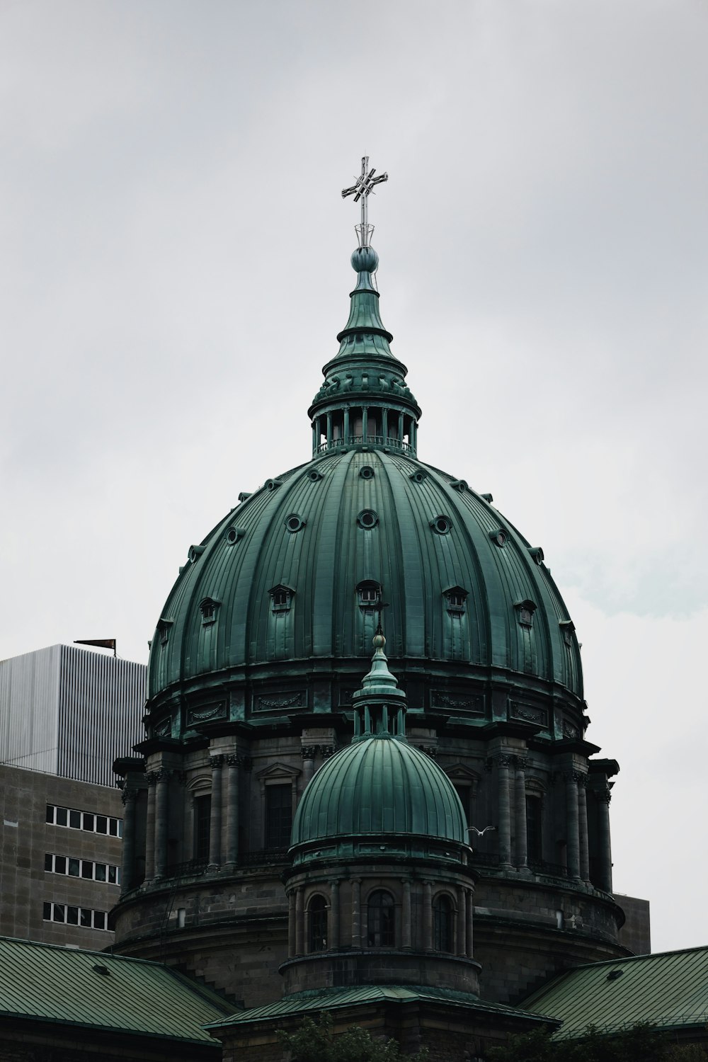 a green dome with a cross on top of it