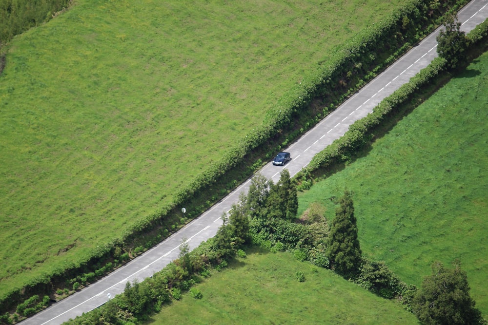 an aerial view of a car driving down a road