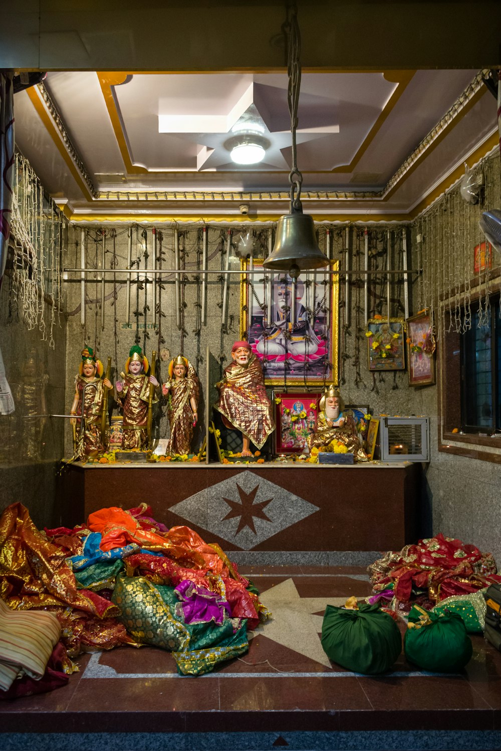 a small shrine with a lot of items on the floor