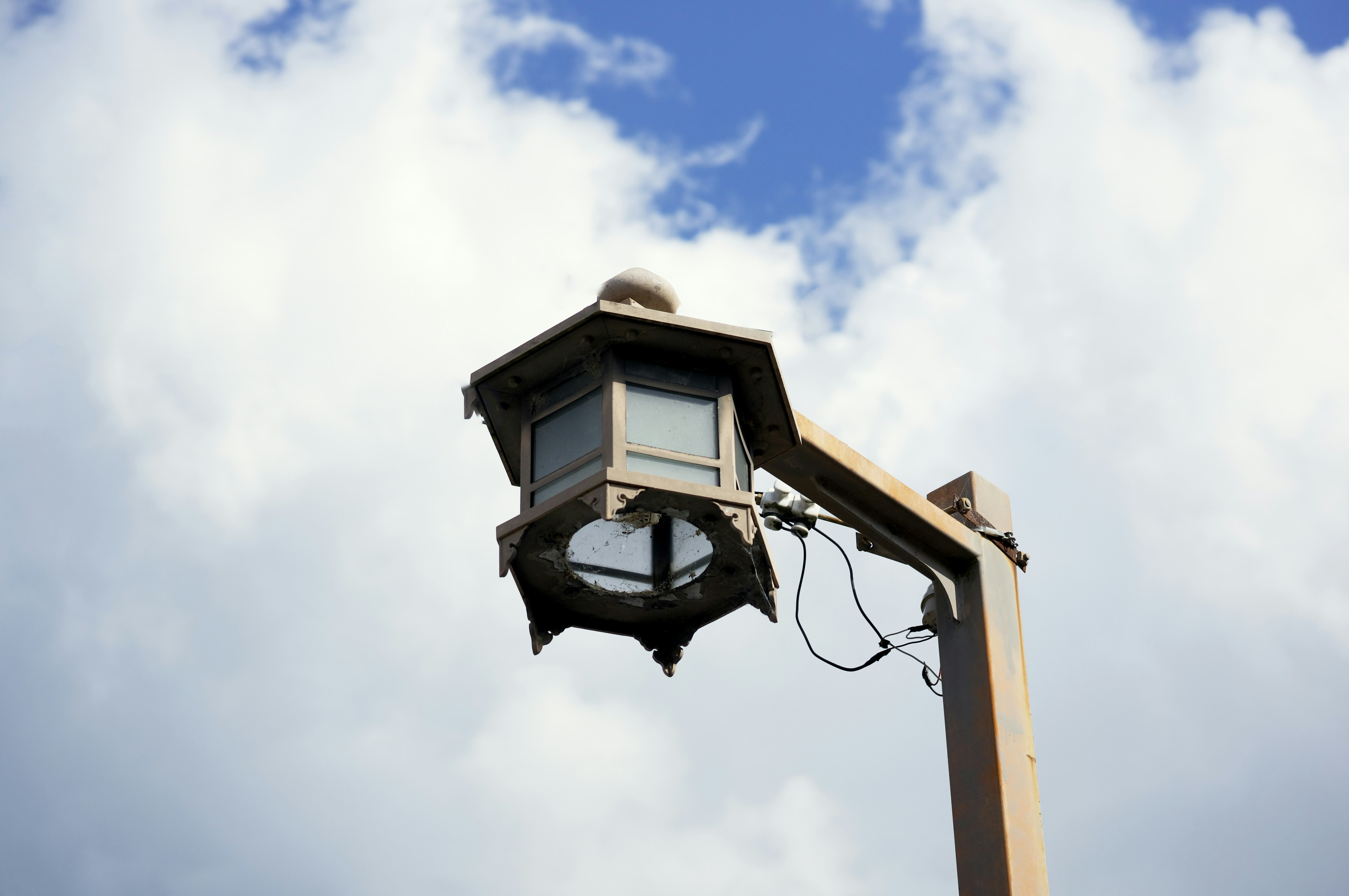 a street light with a cloudy sky in the background