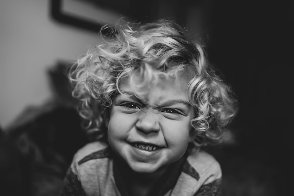 a black and white photo of a child crying