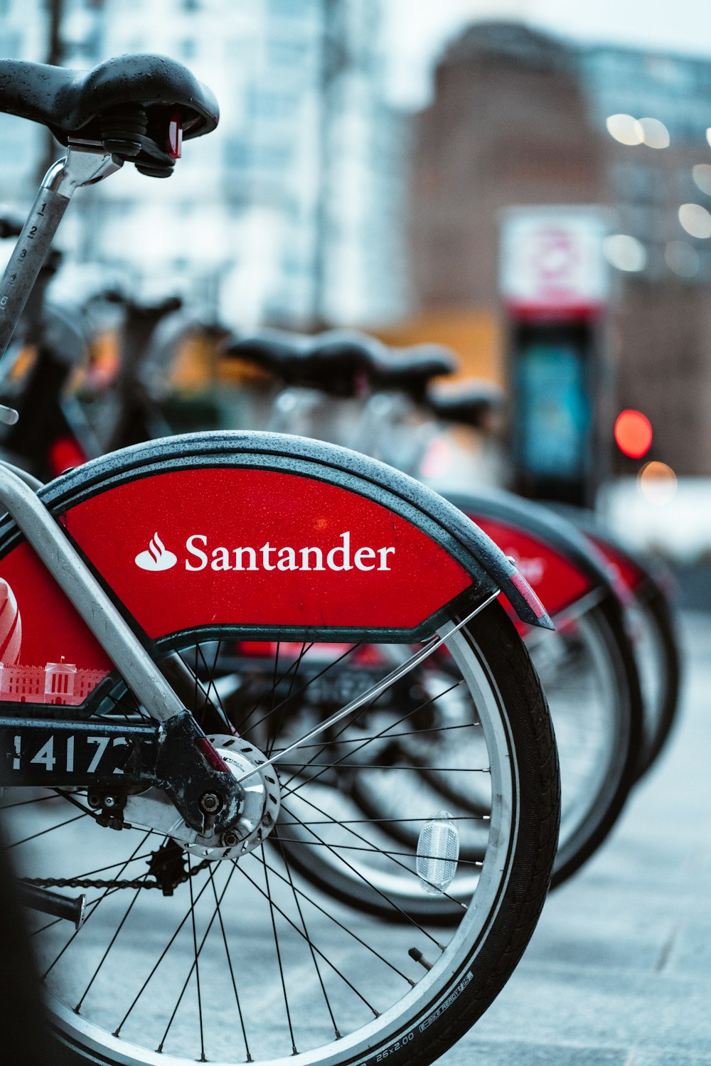 a close up of a red bike parked on a street