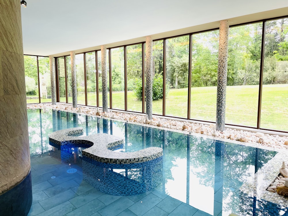 a large indoor swimming pool with a bench next to it