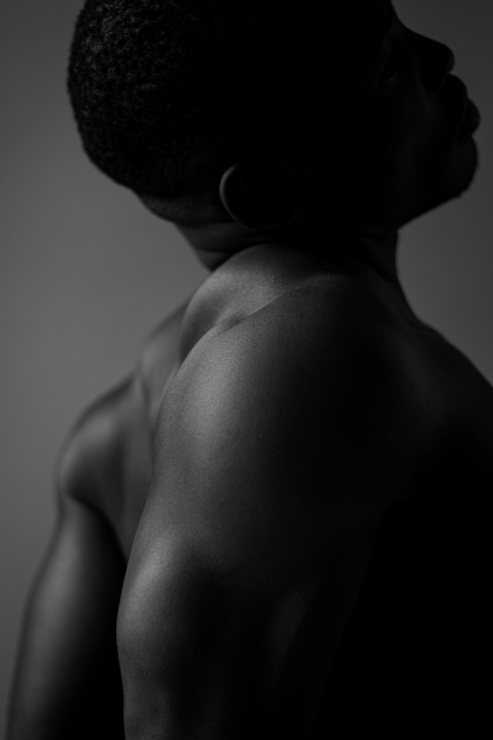 a black and white photo of a man's back