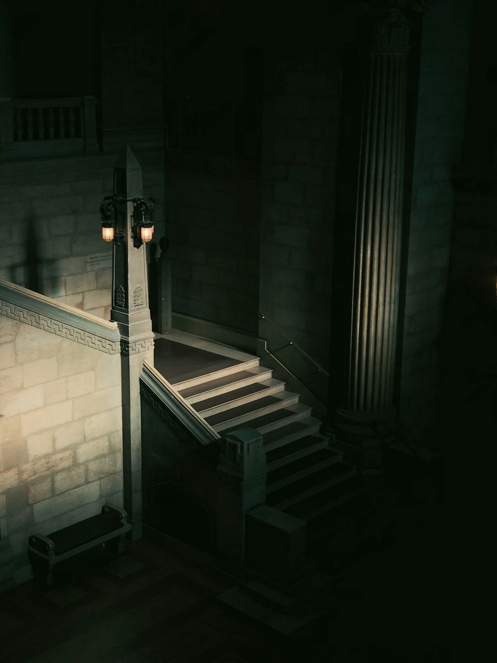 a staircase leading to a light in a dark room