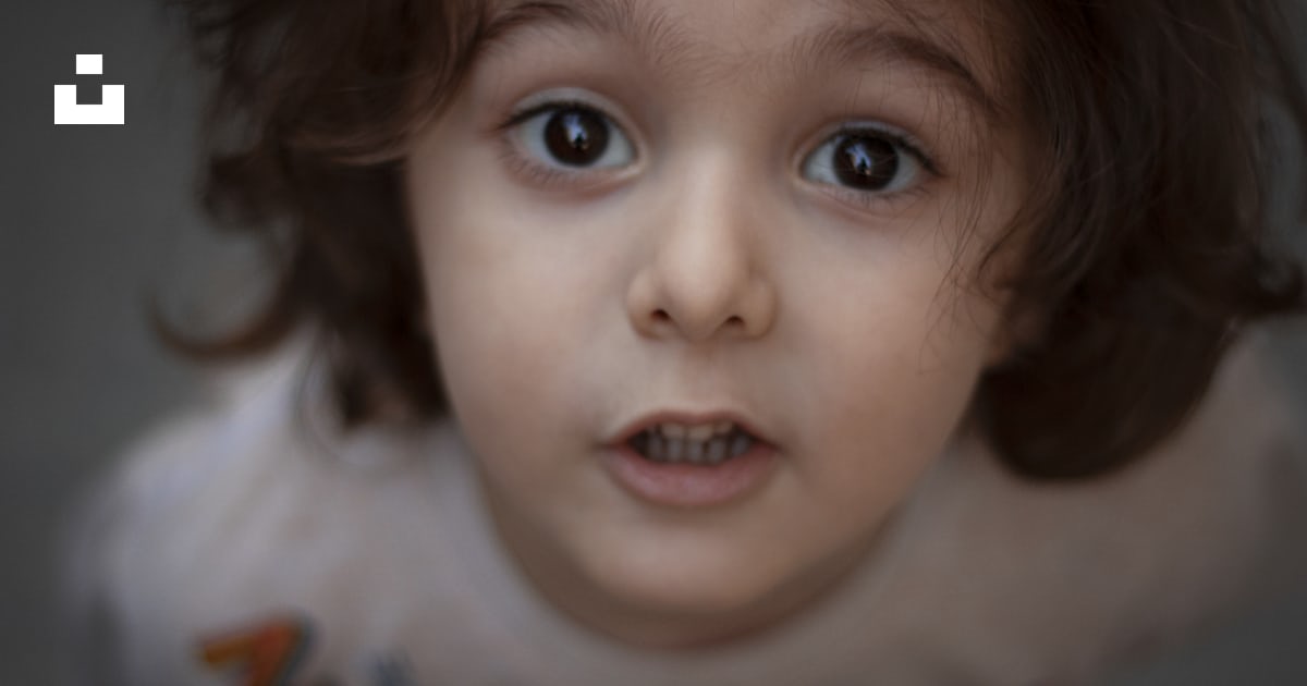A close up of a child’s face with blue eyes photo – Free Texas