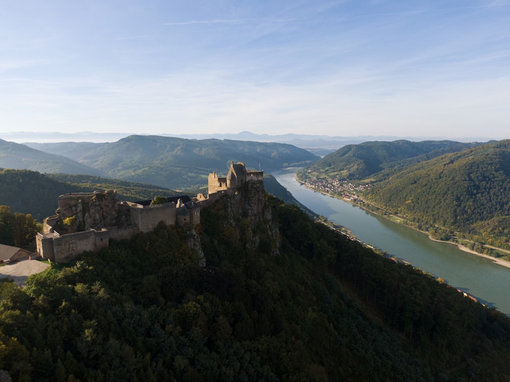 a castle sitting on top of a lush green hillside