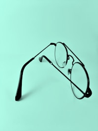 a pair of glasses sitting on top of a table