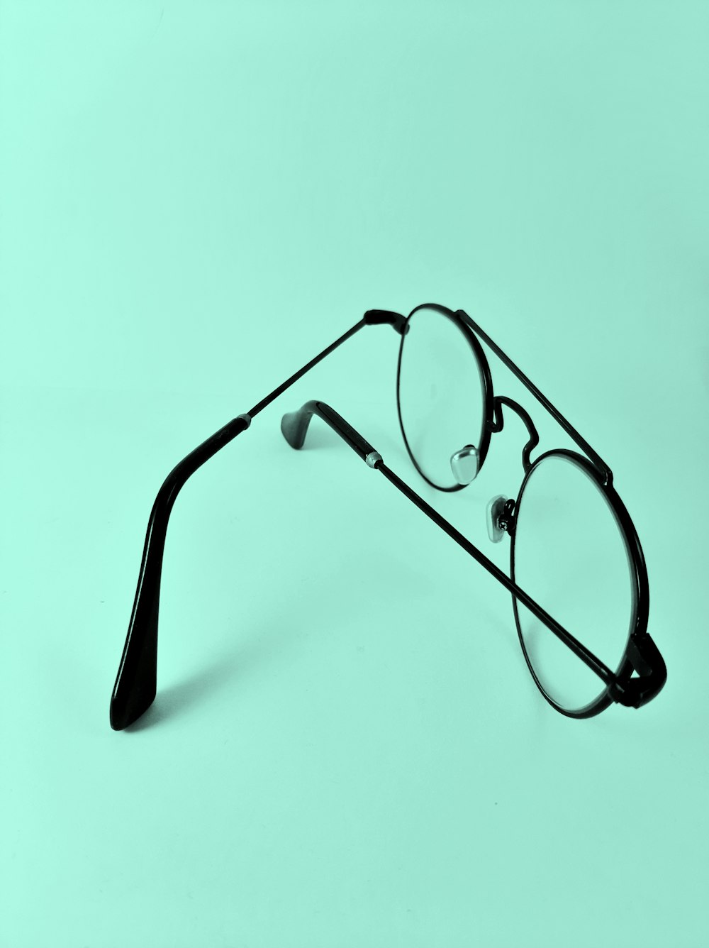 a pair of glasses sitting on top of a table