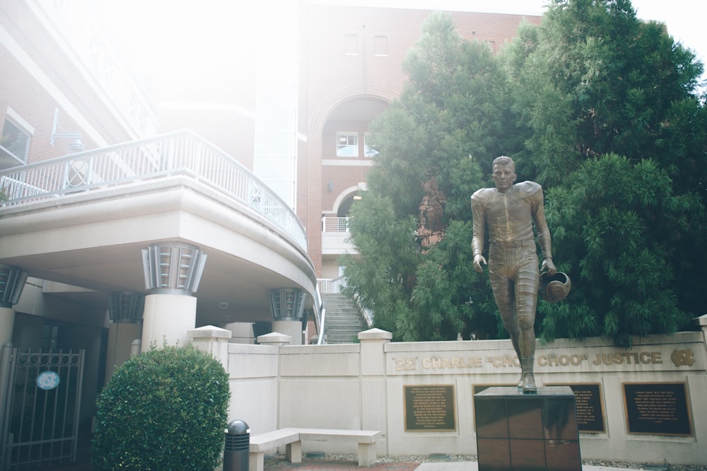 a statue of a man in front of a building