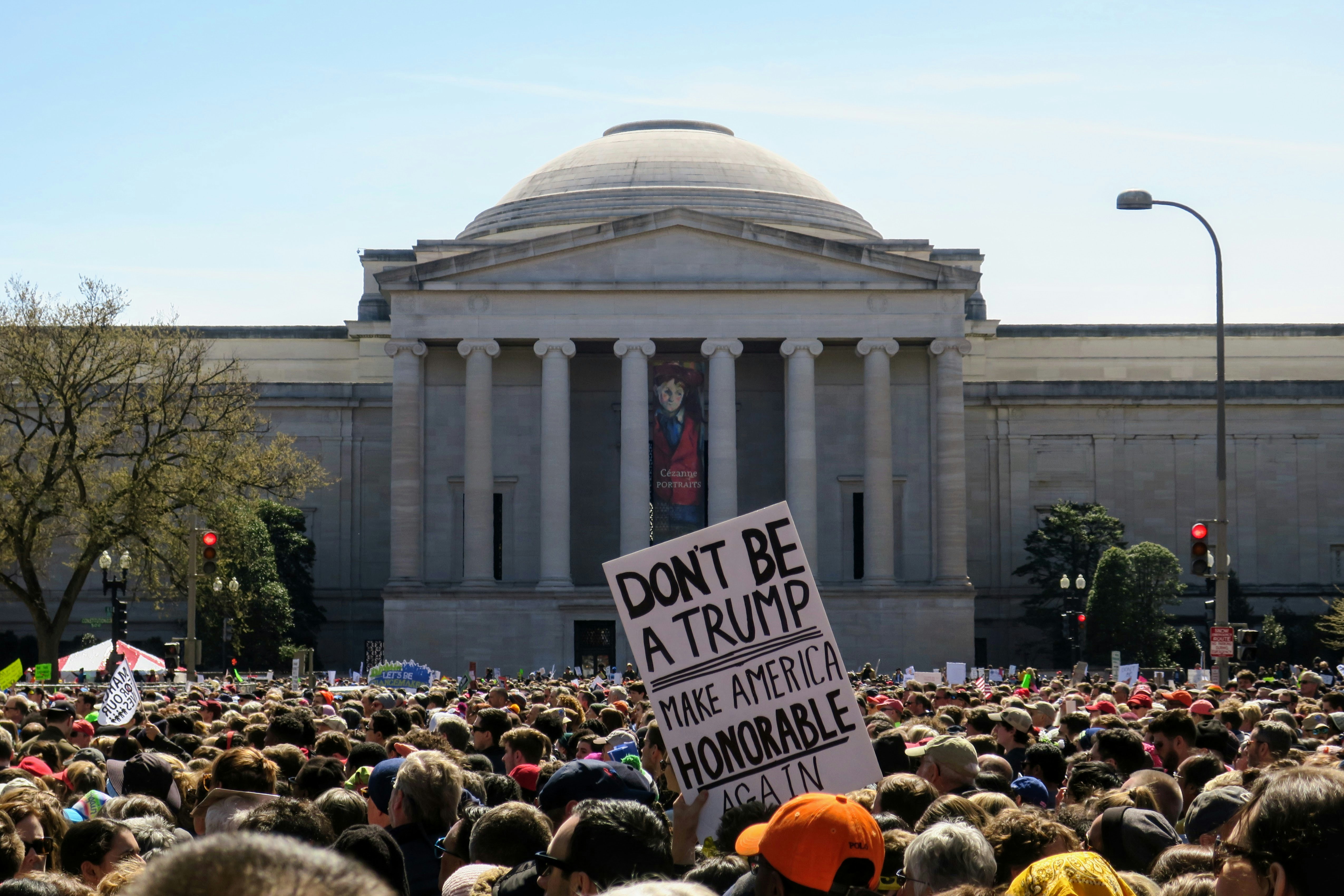 a large crowd of people standing in front of a building