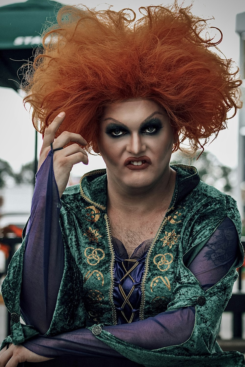 a man with red hair wearing a costume