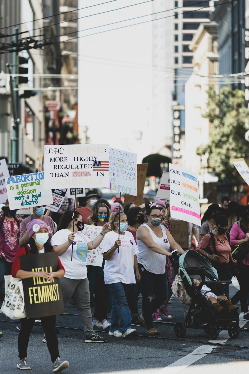 a group of people marching down a street holding signs