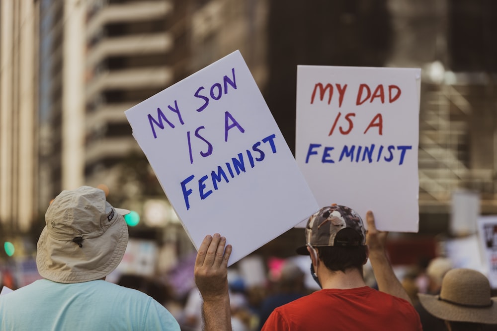 a couple of people that are holding signs