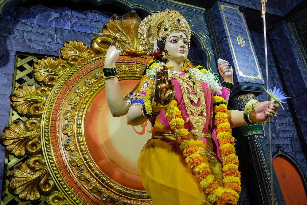 a statue of a hindu god holding a sword