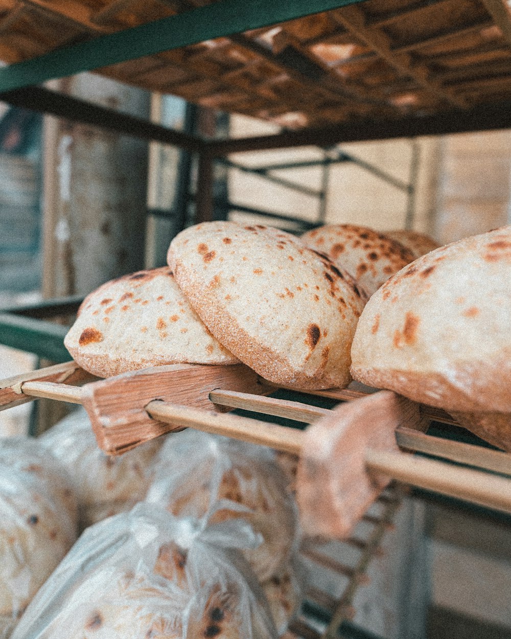 a bunch of breads that are on a rack