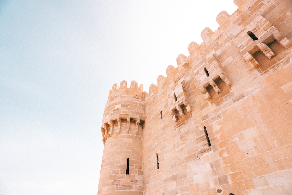 a large stone castle with a clock on it's side