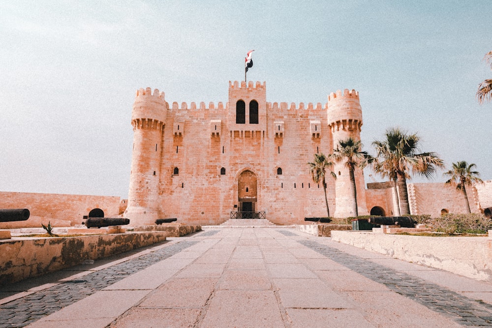 a castle like building with a flag on top of it