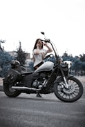 a woman sitting on a motorcycle talking on a cell phone