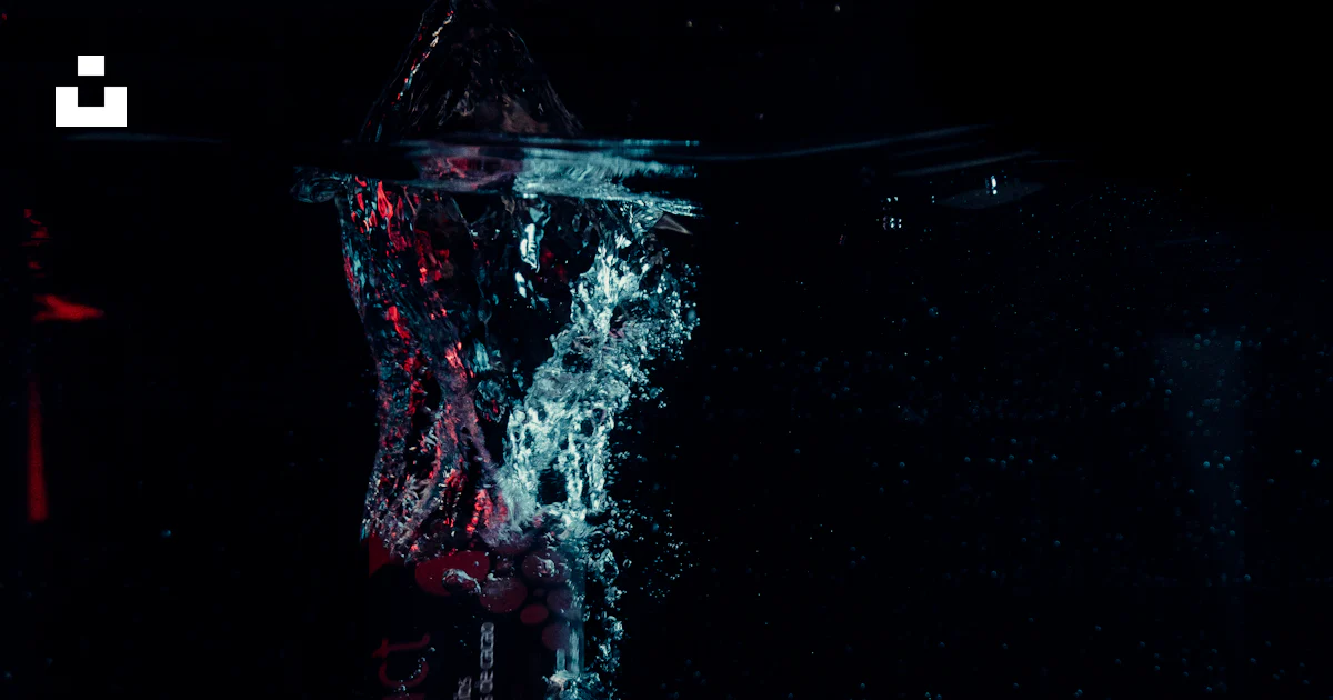 A large object floating in the water at night photo – Free Canmore ...