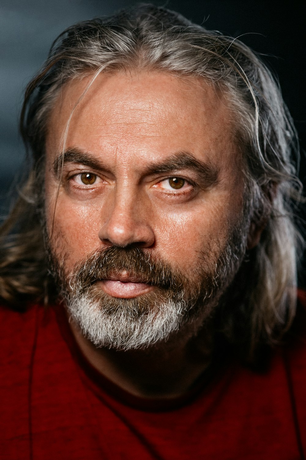 a close up of a person wearing a red shirt