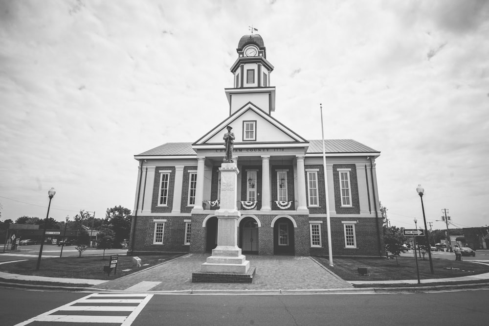 a black and white photo of a building with a clock tower