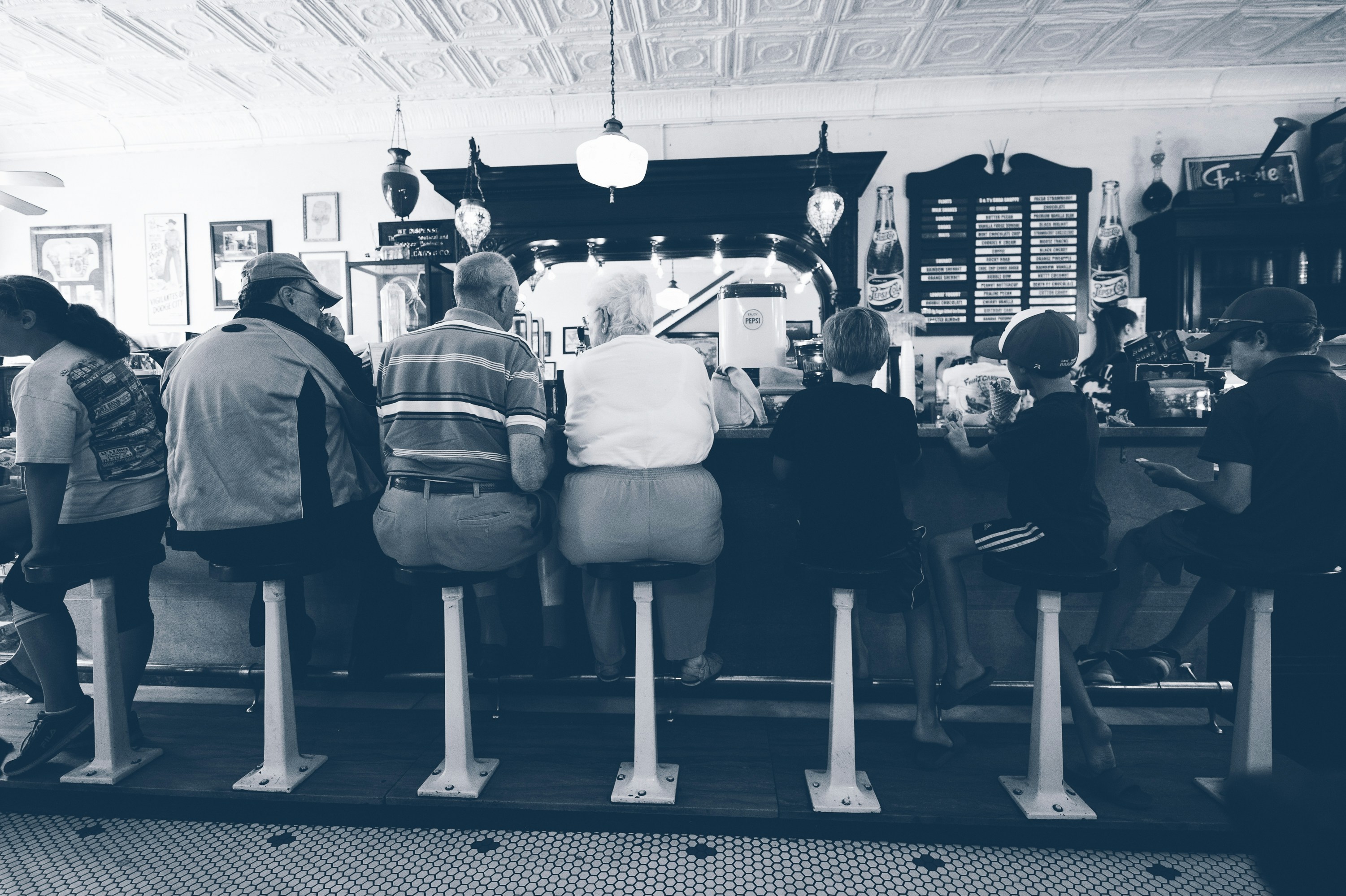 A split image showing: on one side, a long queue of people at a traditional train ticket counter in the past; on the other side, a person comfortably booking a ticket on a tablet at home.