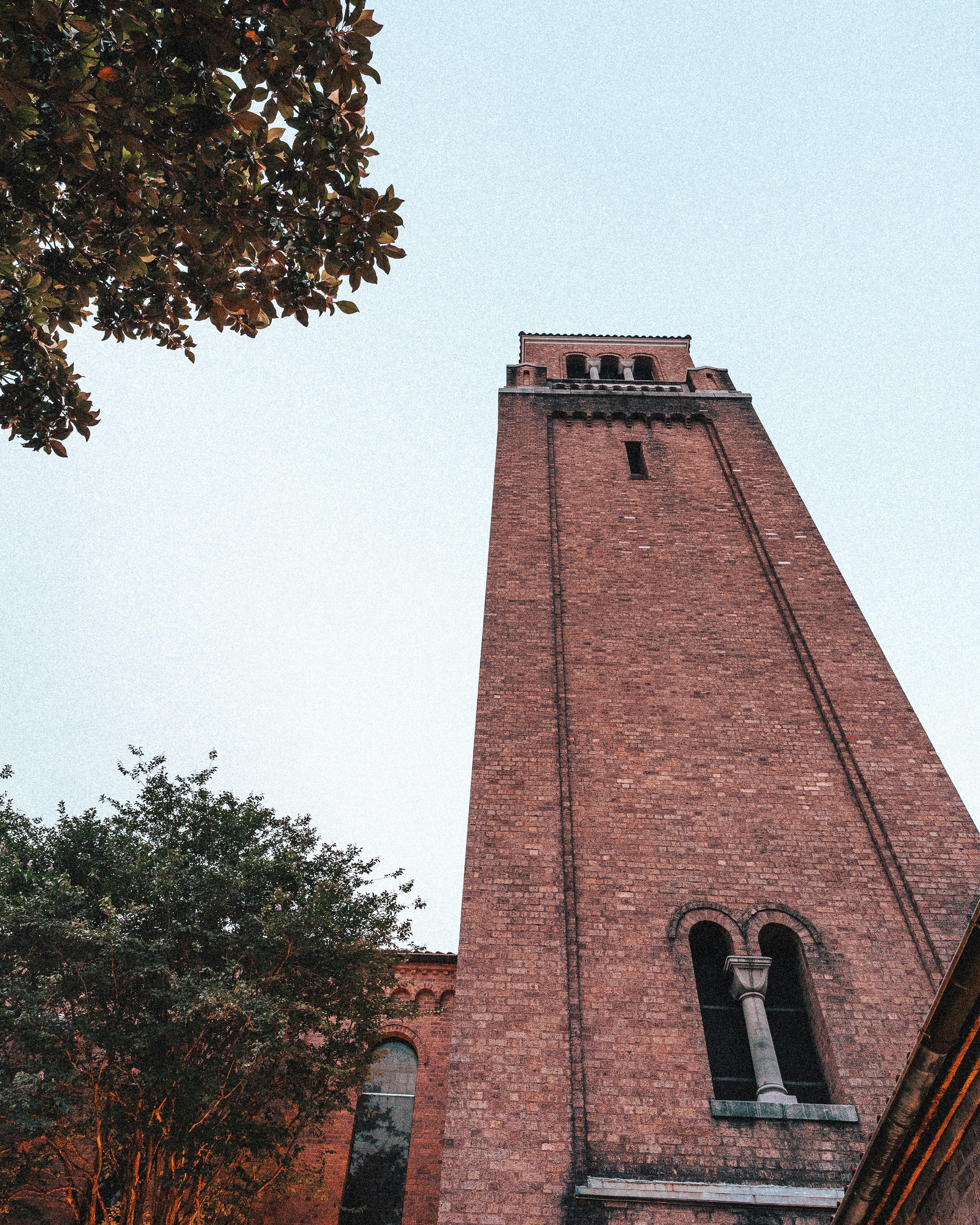 a tall brick tower with a clock on it's side
