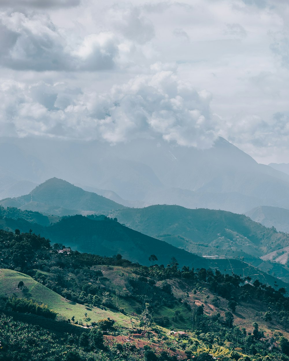 a scenic view of a mountain range with clouds in the sky