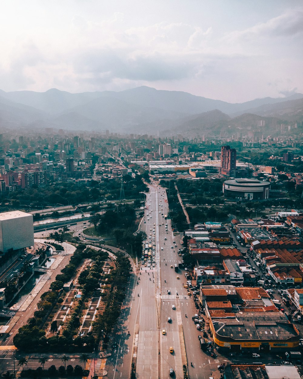 an aerial view of a city with mountains in the background