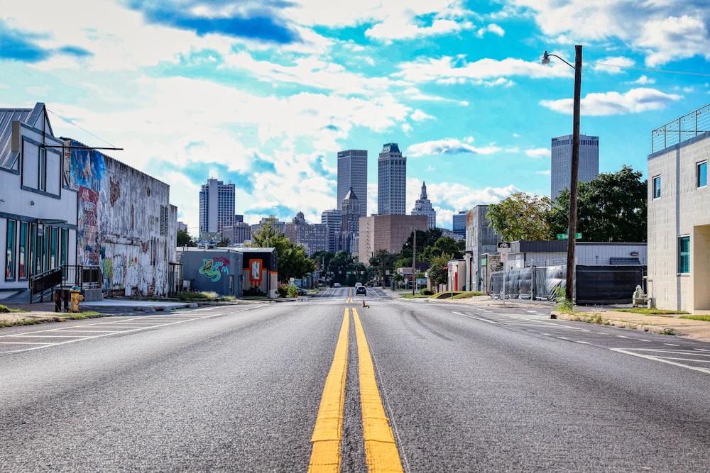 an empty street with buildings in the background