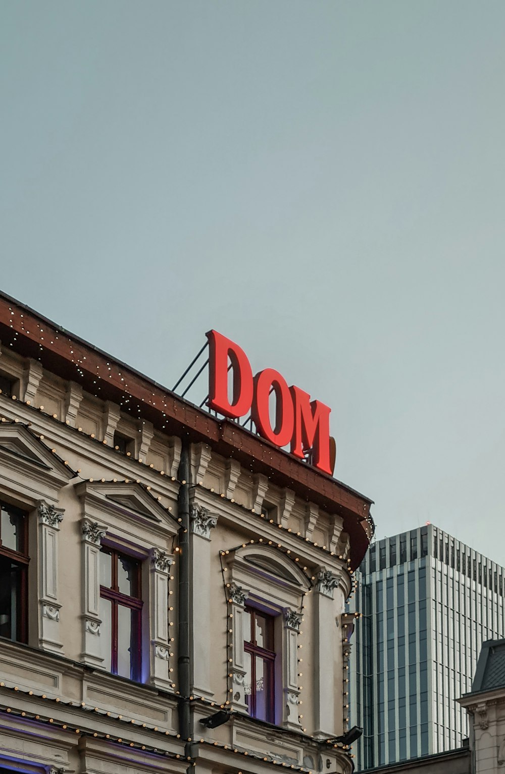 a building with a sign that says dom on top of it