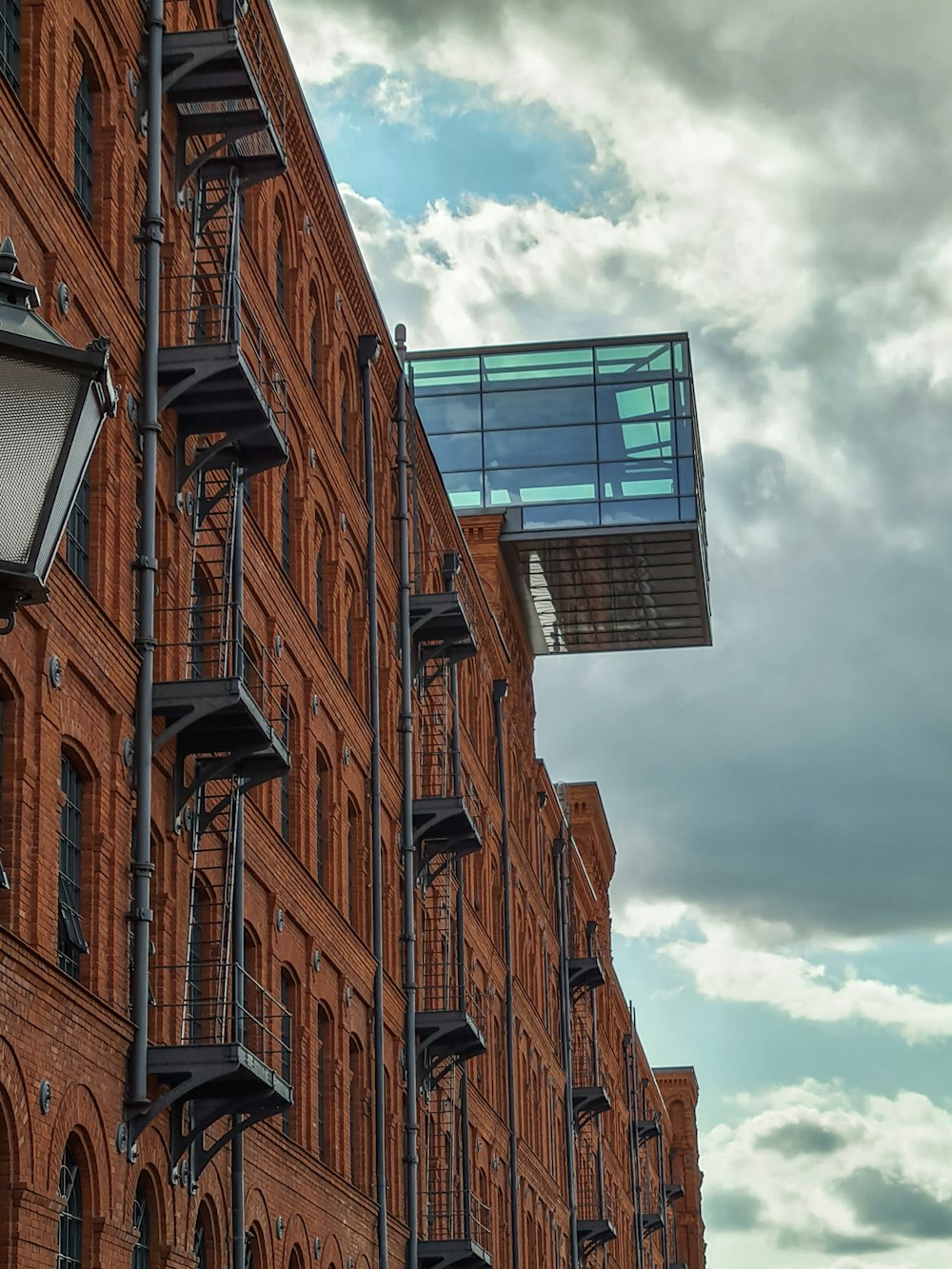 a tall brick building with a sky background