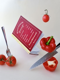 a knife and some tomatoes on a table