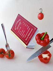 a knife and some tomatoes on a table