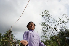 A candid shot of a child's laughter during a birthday party outdoors.