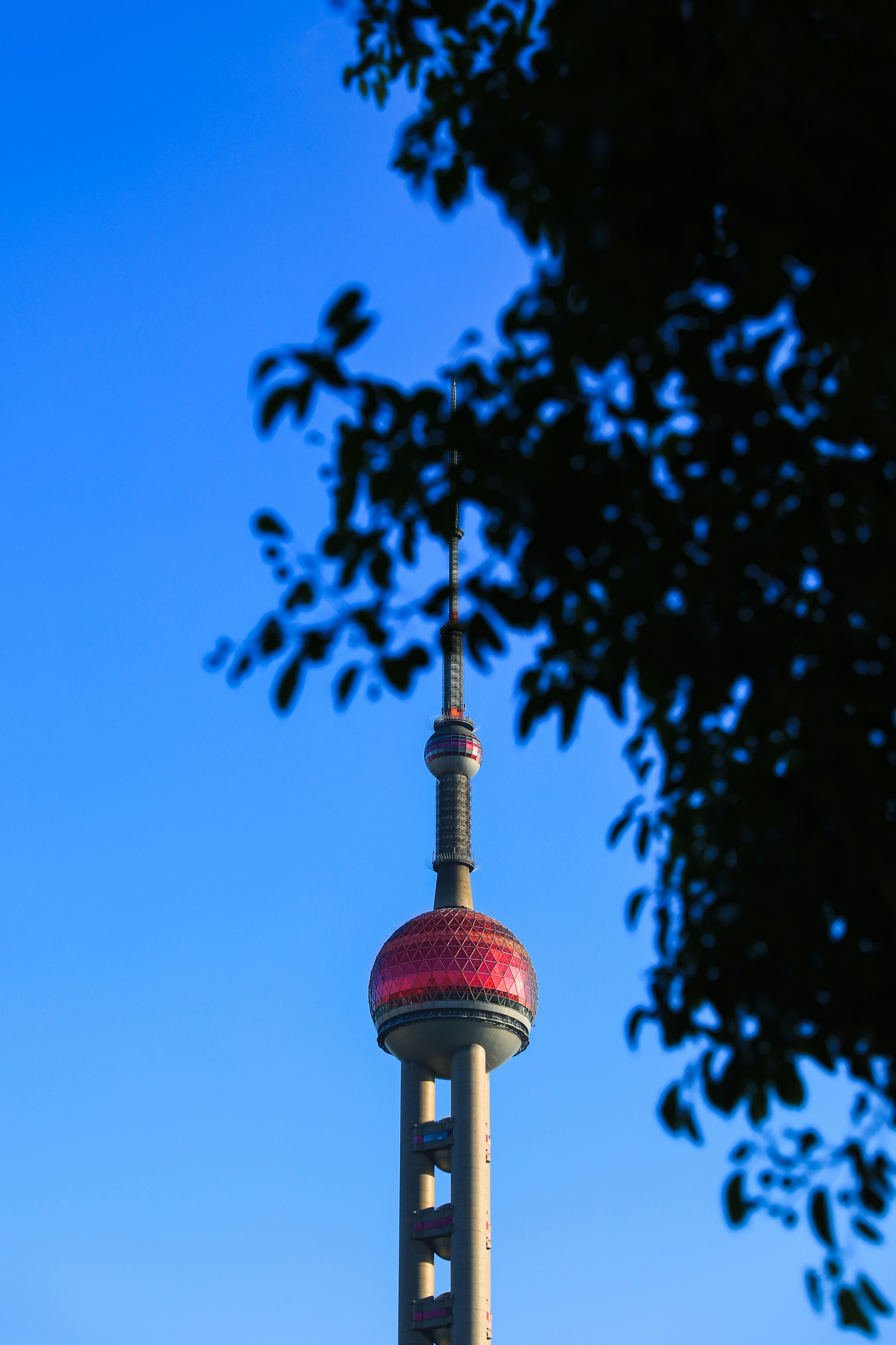 a tall tower with a red top and a sky background