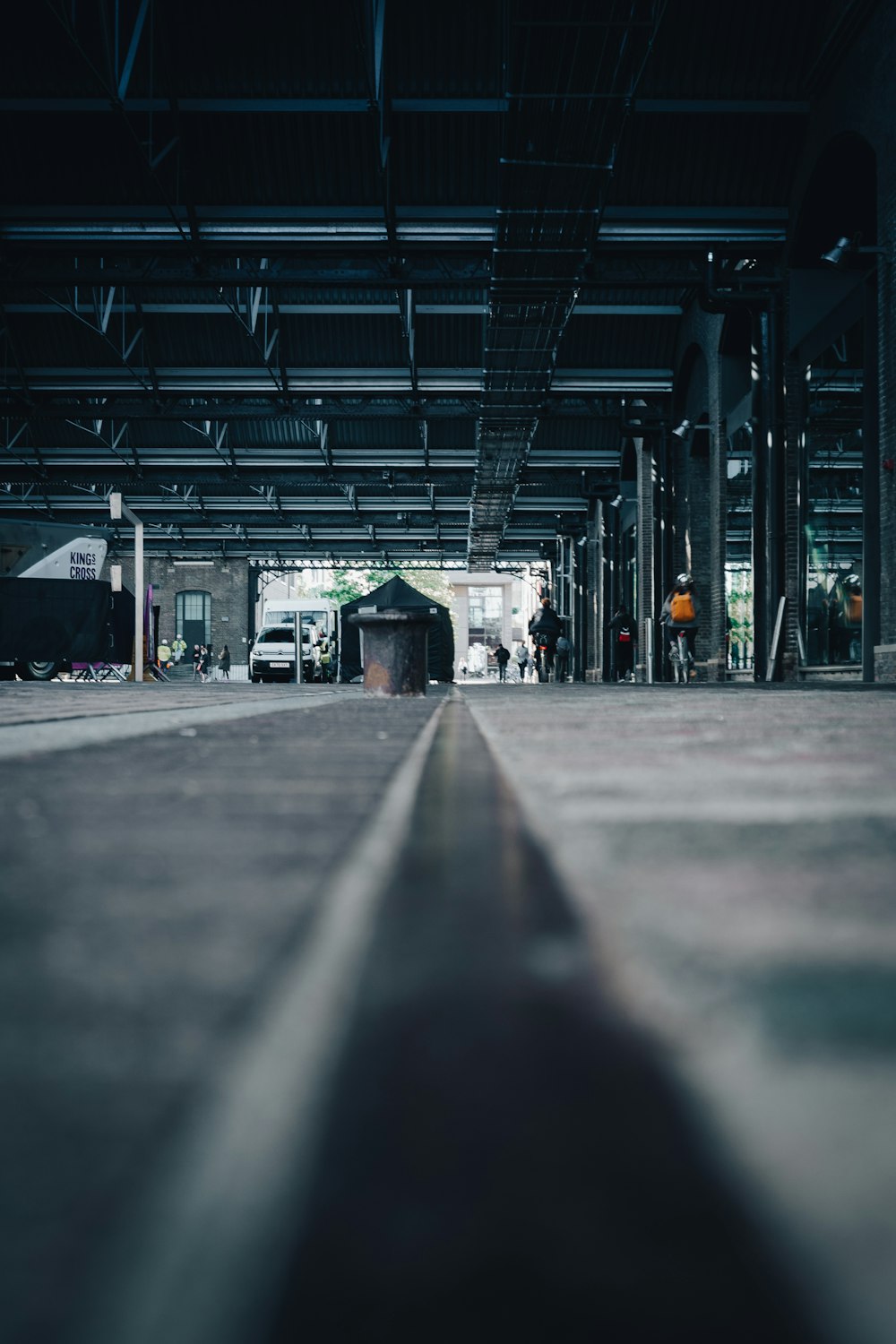 an empty parking garage with a few cars parked in it