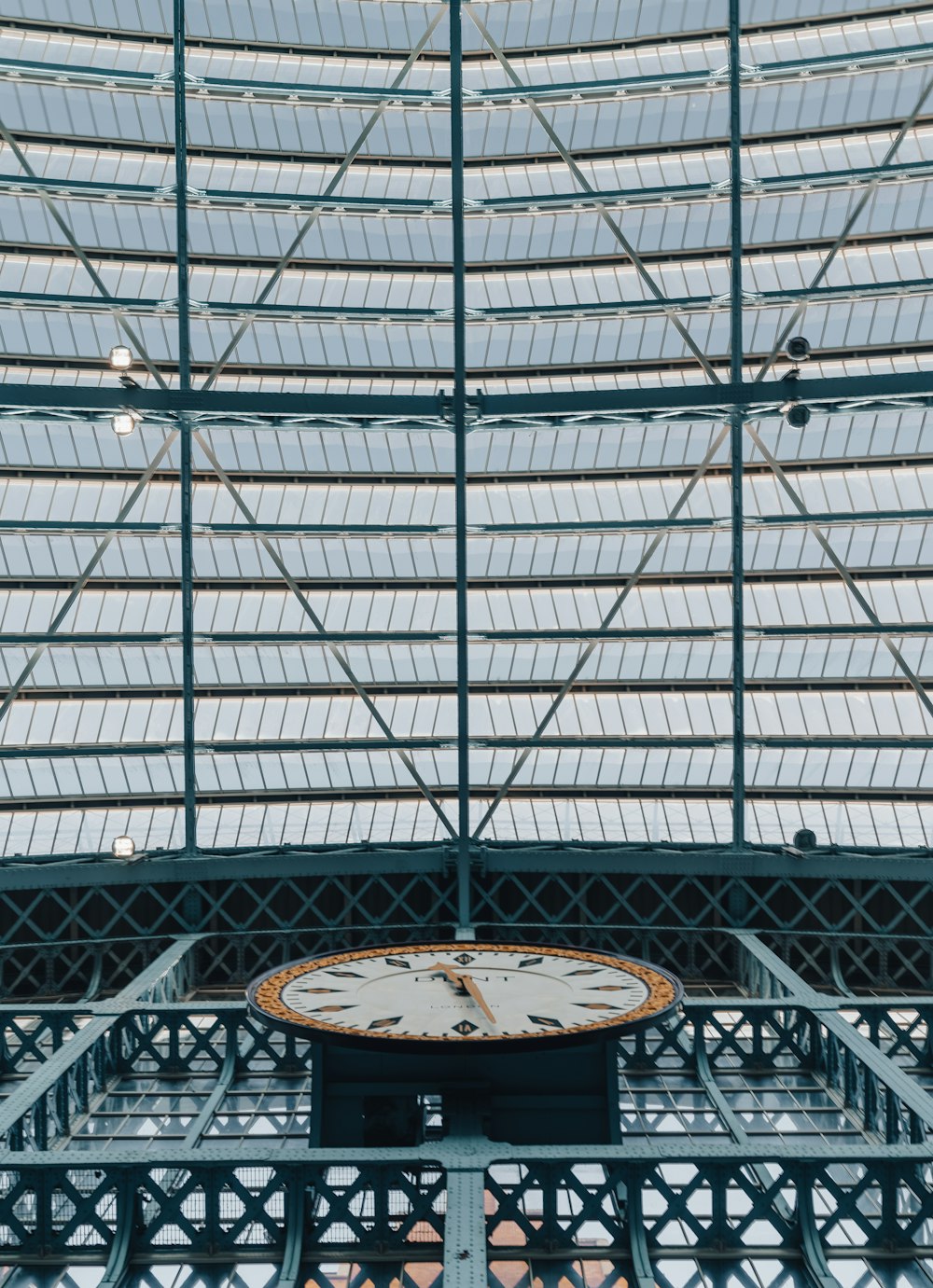 a clock sitting in the middle of a train station