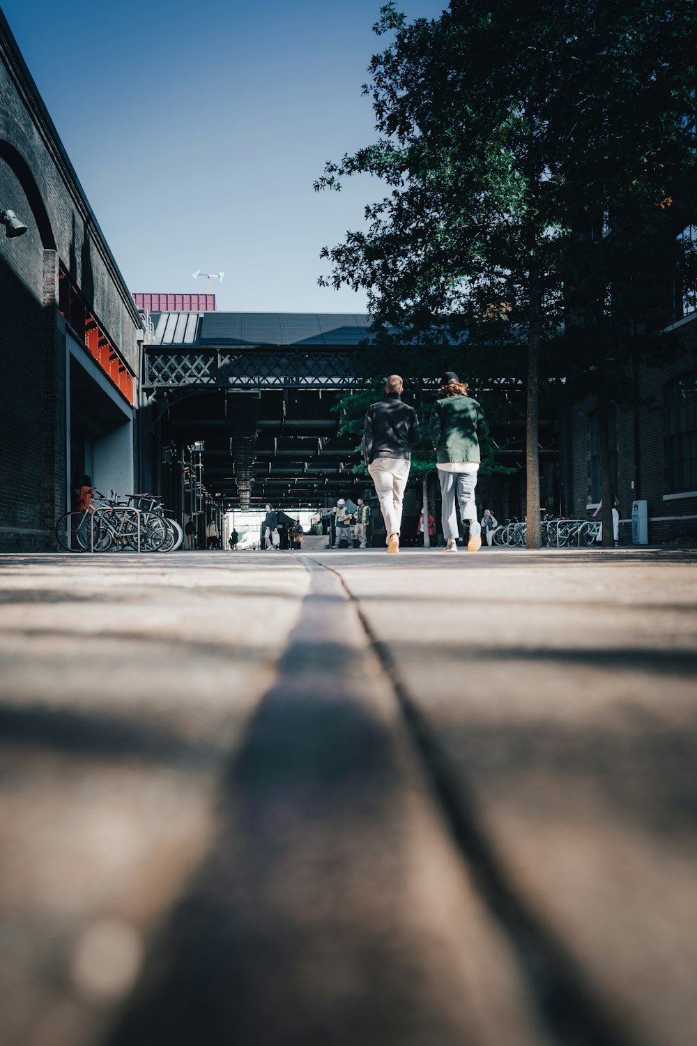 a couple of people walking down a street