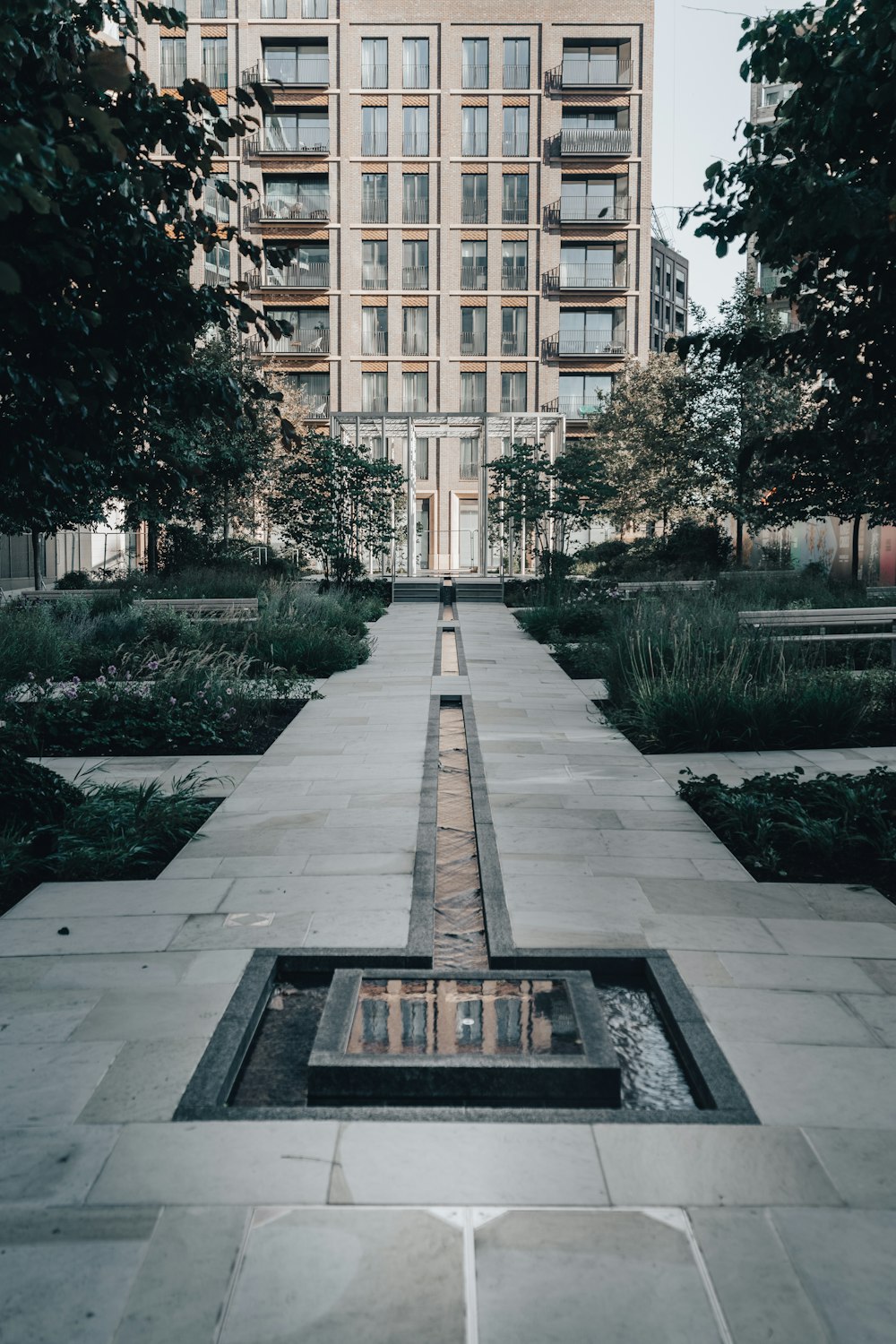 a large building with a fountain in the middle of it