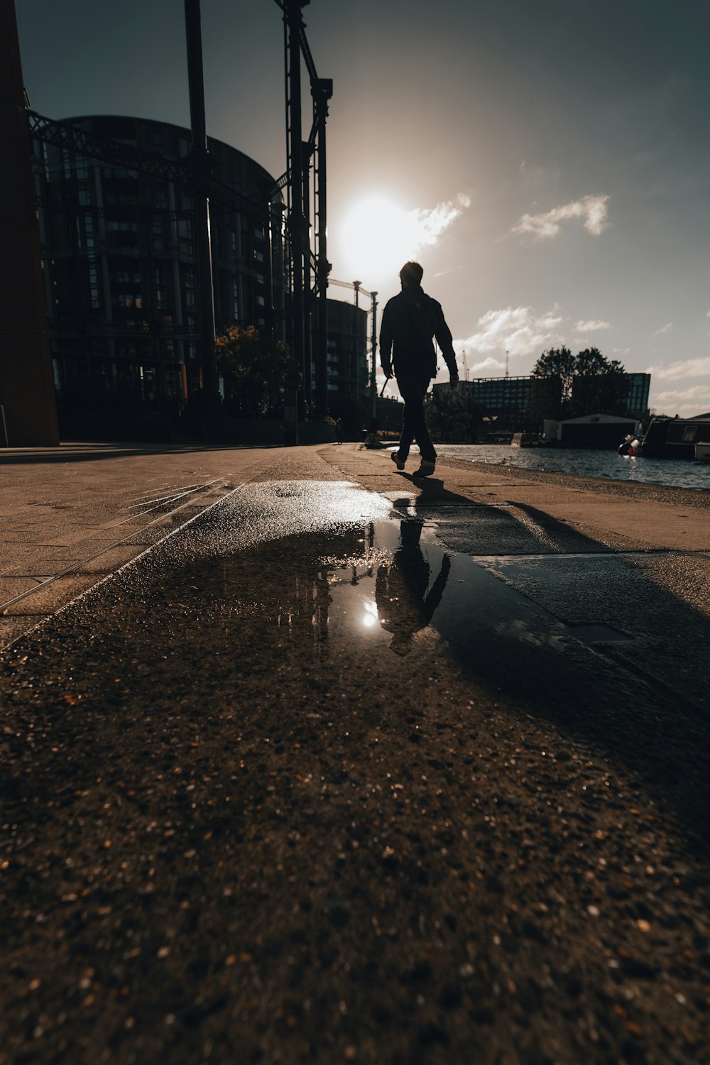 a man riding a skateboard across a puddle of water
