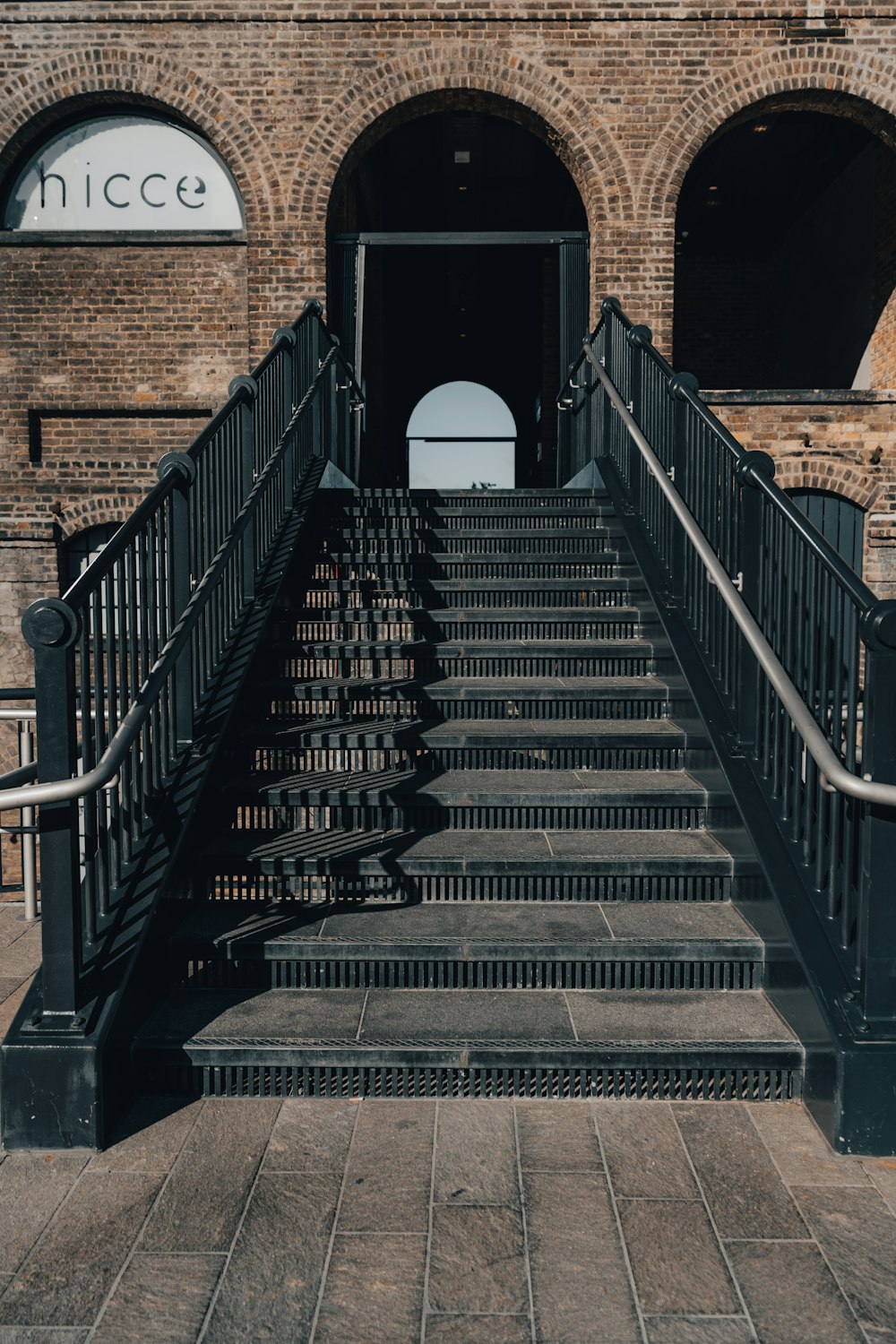 a set of stairs leading up to a brick building