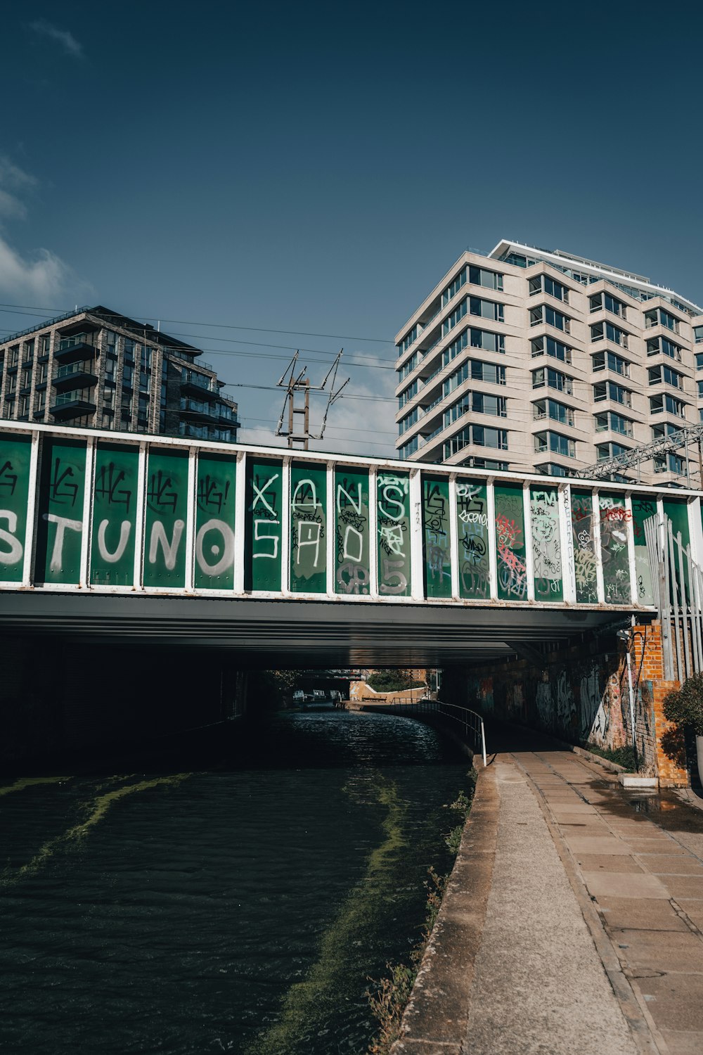 a bridge that has graffiti on the side of it