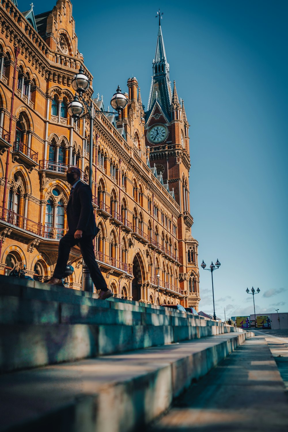 a man walking up some steps in front of a building